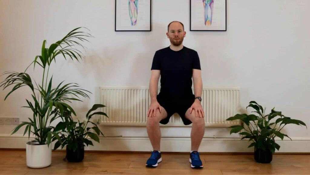 Picture of James McCormack performing a wall sit exercise